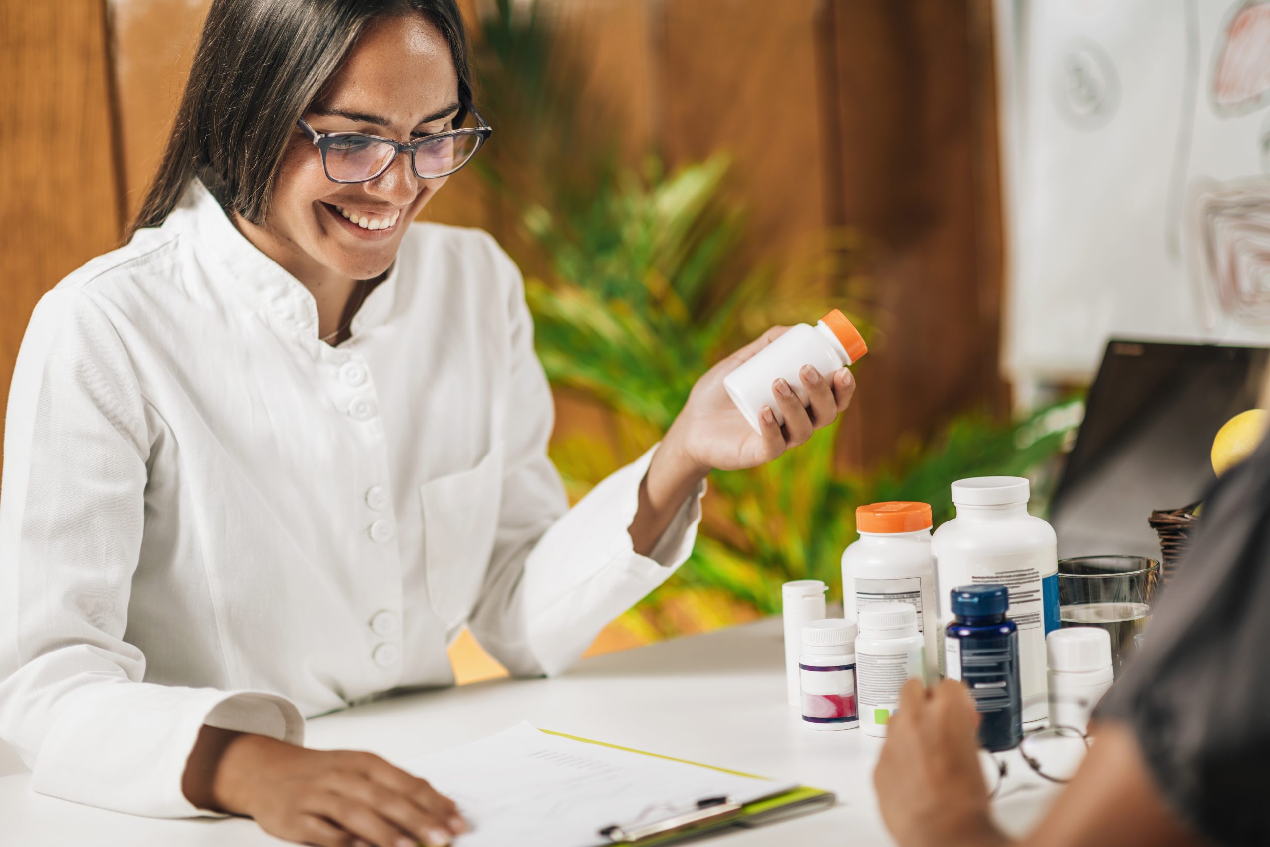 Functional Medicine Female Practitioner Recommending Dietary Supplement to a Client